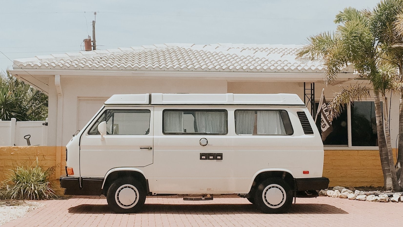 White van parked near a house | Breast Cancer Car Donations