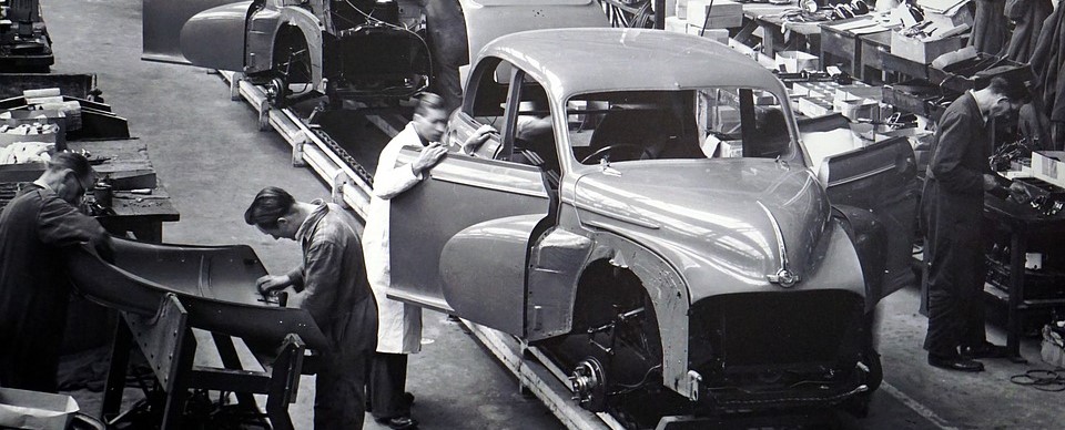Old Picture of a Man working hard in a Car Factory | Breast Cancer Car Donations