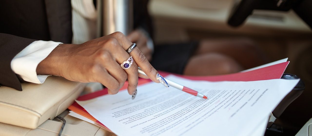 Person Reading Car Documents | Breast Cancer Car Donations