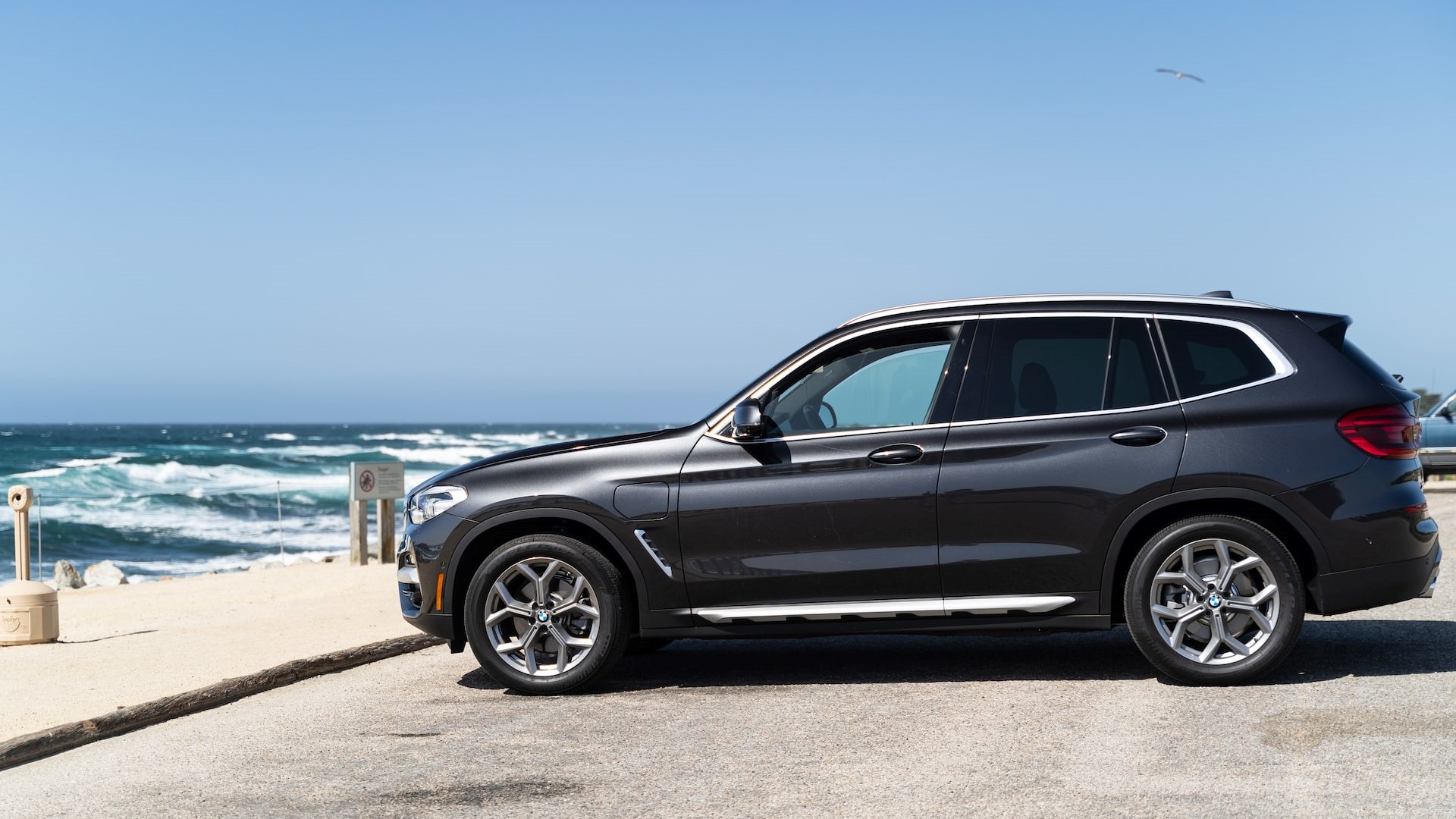 Black suv parked near the shore | Breast Cancer Car Donations