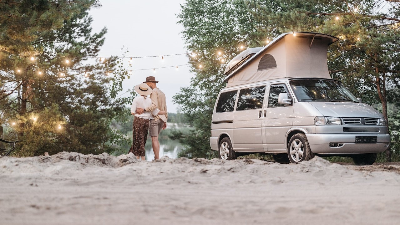 Couple near a gray camper van | Breast Cancer Car Donations