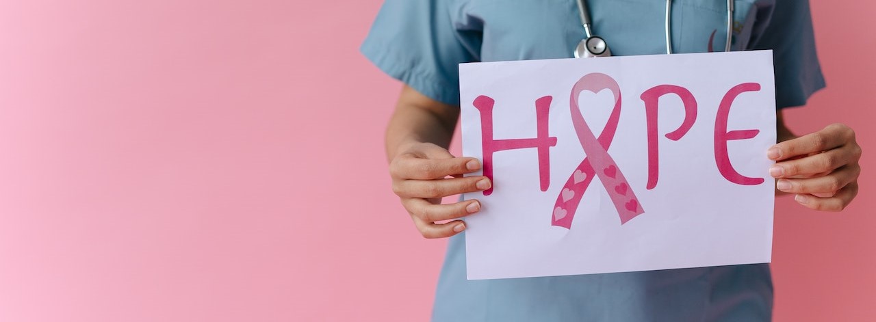 Nurse holding a hope signage | Breast Cancer Car Donations