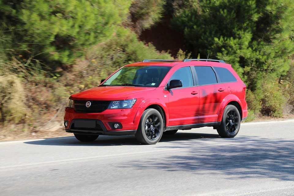 Red Minivan on the Road | Breast Cancer Car Donations