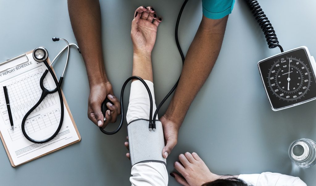Medical Personnel Taking Blood Pressure to a Patient | Breast Cancer Car Donations