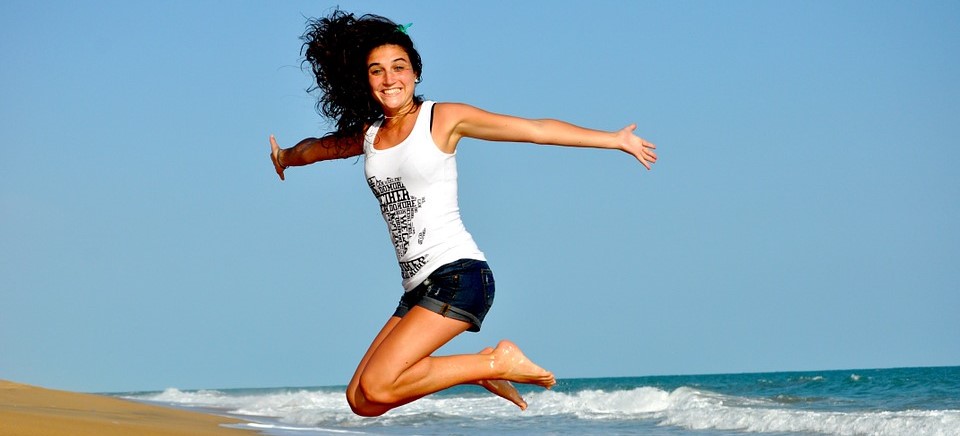 Woman Jumping at the Beach - CarDonations4Cancer.org