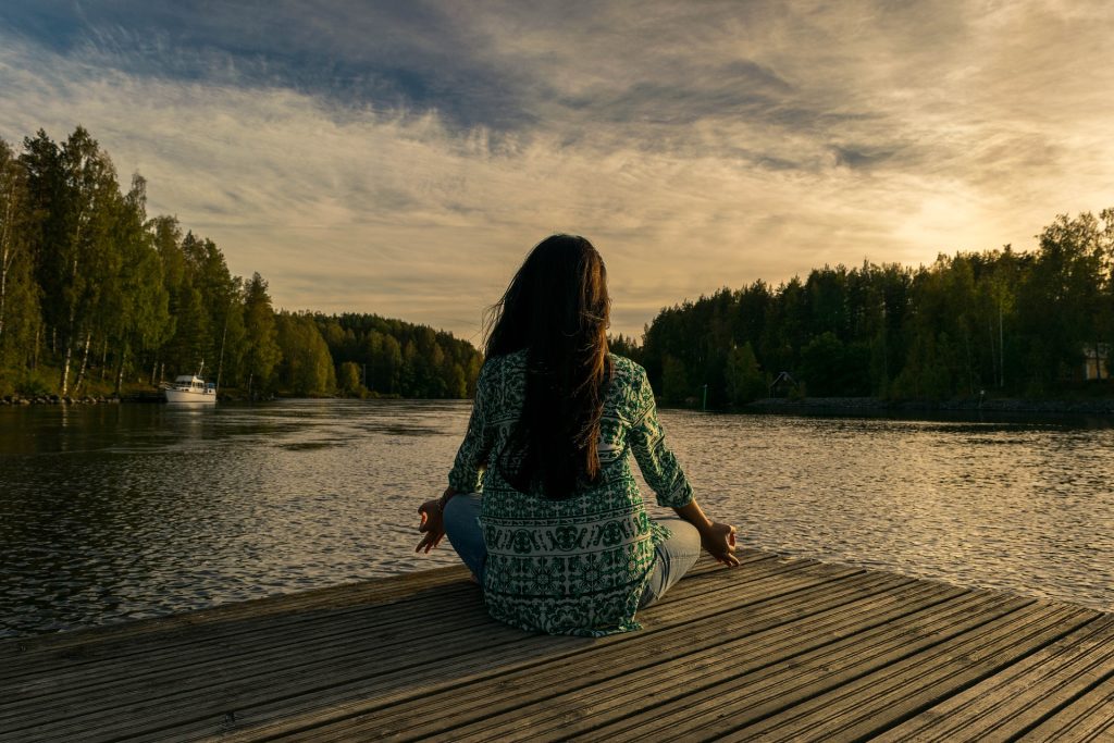 Woman Relaxing on a River Dock | Breast Cancer Car Donations
