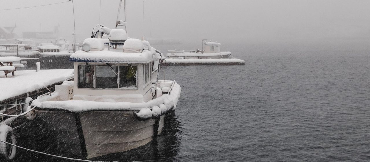 Boat covered in snow at the dock | Breast Cancer Car Donations