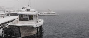 Boat covered in snow at the dock | Breast Cancer Car Donations