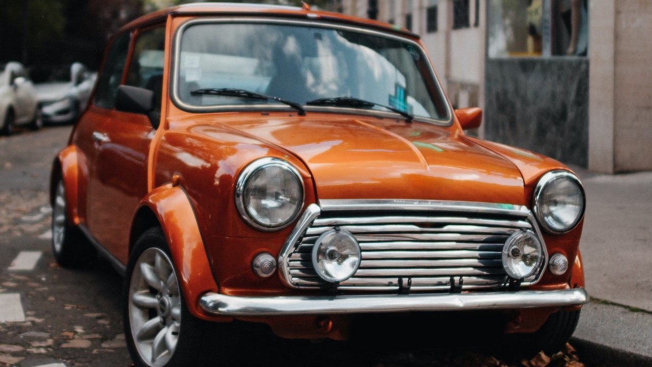 Orange mini copper parked | Breast Cancer Car Donations