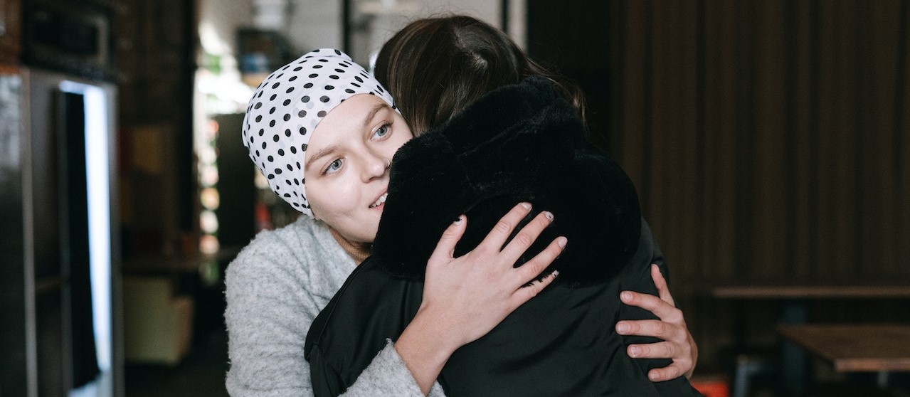 Woman with cancer hugging a visitor | Breast Cancer Car Donations