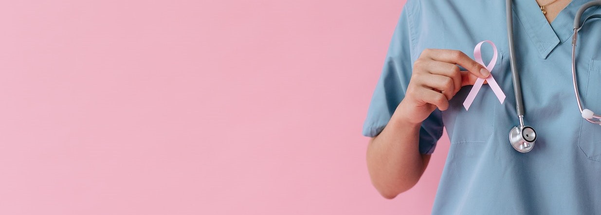 A Healthcare Professional Holding a Pink Ribbon | Breast Cancer Car Donations