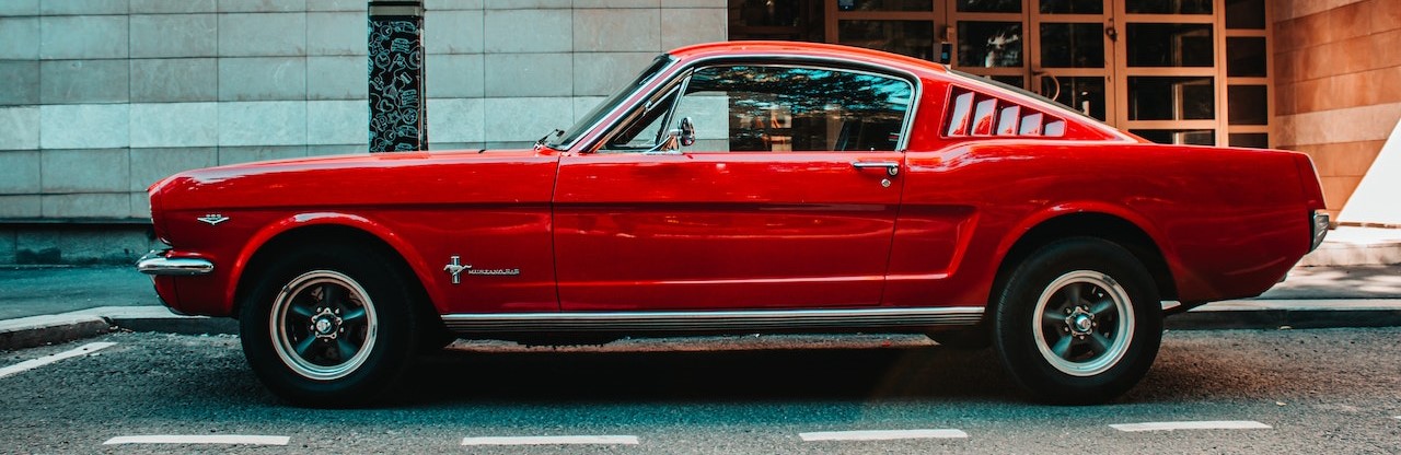A Red Ford Mustang Parked on the Street | Breast Cancer Car Donations