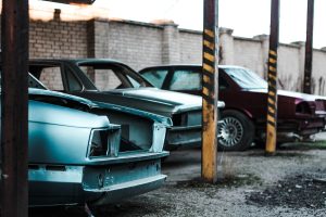 Broken cars on parking lot | Breast Cancer Car Donations