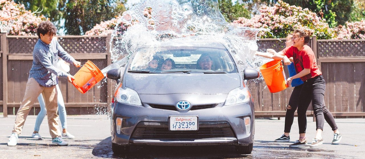 Four Children Washing Silver Toyota Prius | Breast Cancer Car Donations