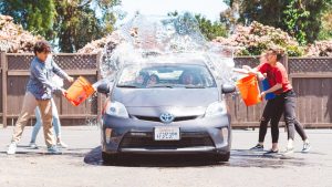 Four Children Washing Silver Toyota Prius | Breast Cancer Car Donations