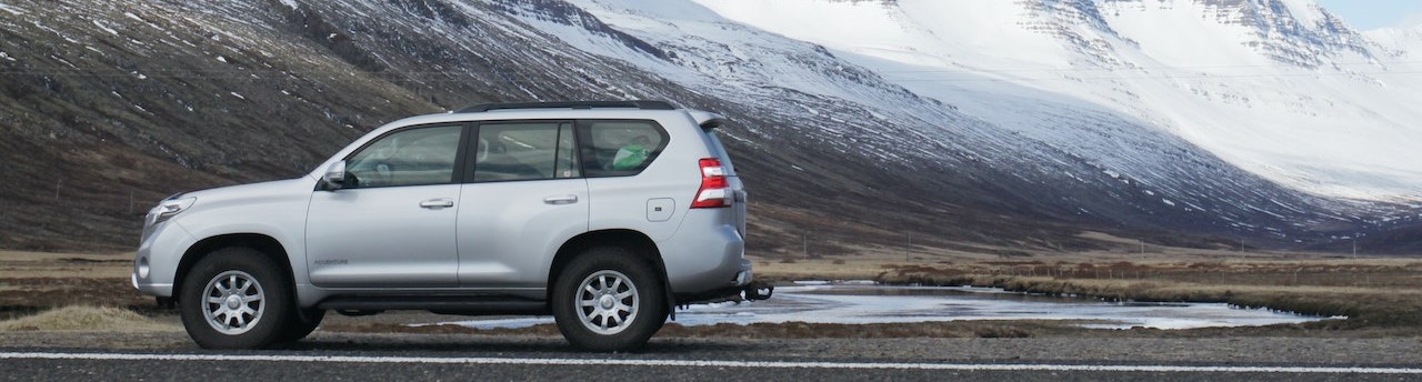 Gray Sports Utility Vehicle on Road Near Snow Covered Mountain | Breast Cancer Car Donations