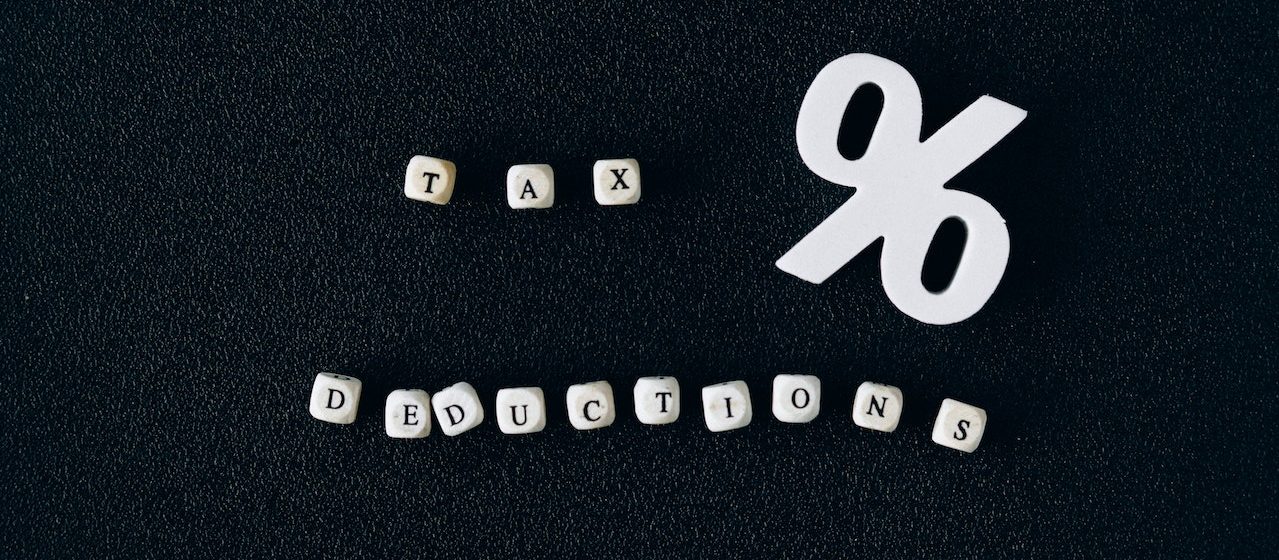 Tax Deductions Words on Black Surface | Breast Cancer Car Donations