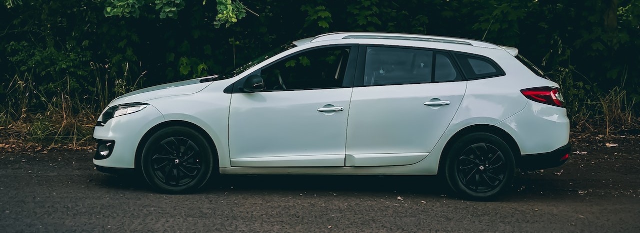 White Car Parked Beside Green Trees | Breast Cancer Car Donations