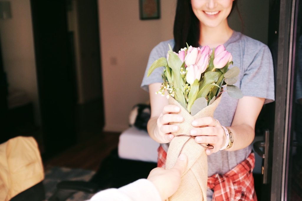 Woman with a Bouquet of Flowers | Breast Cancer Car Donations