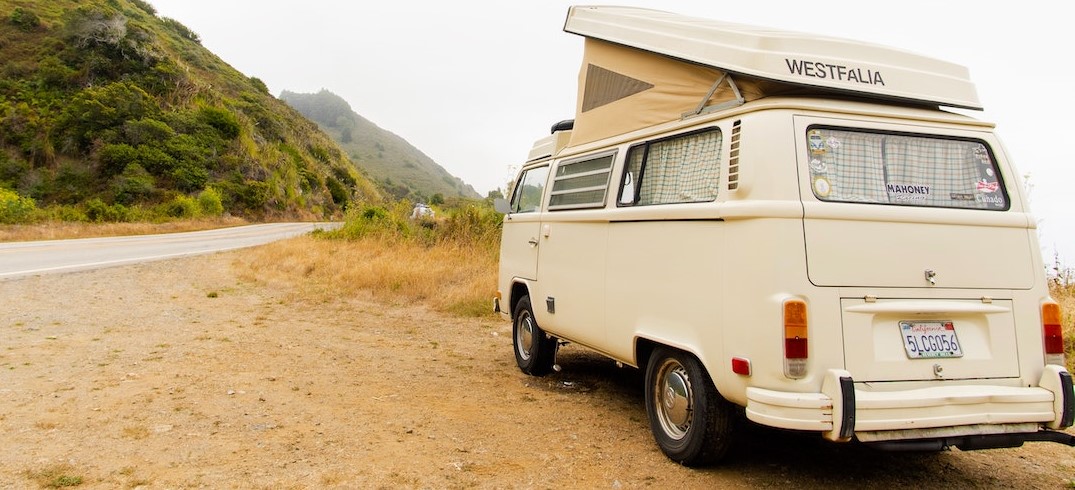 A Classic Campervan Parked on a Dirt Road | Breast Cancer Car Donations