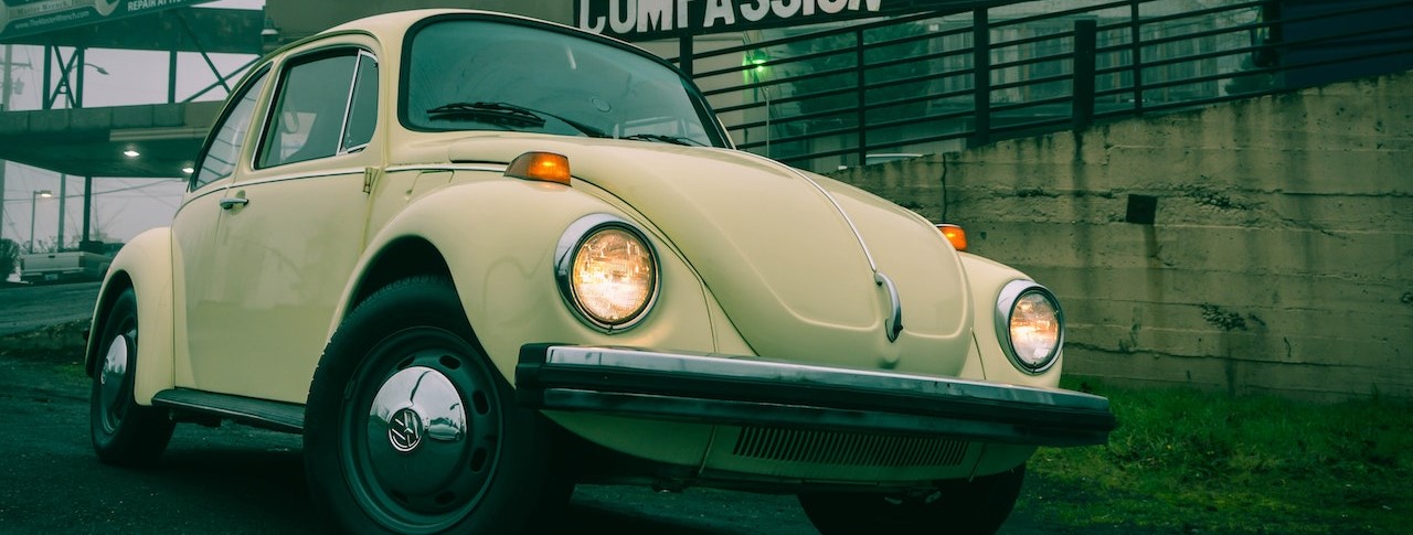 A Volkswagen Beetle Parked on an Asphalt Road | Breast Cancer Car Donations