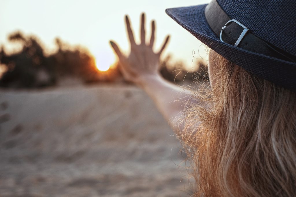 Woman Gesturing Five on a Sunset | Breast Cancer Car Donations