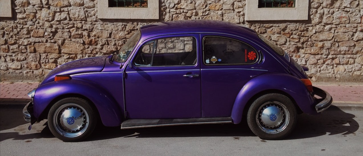 Purple Volkswagen Beetle Parked on the Street | Breast Cancer Car Donations