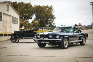 Two Black Vintage Cars Parked Near a Building | Breast Cancer Car Donations