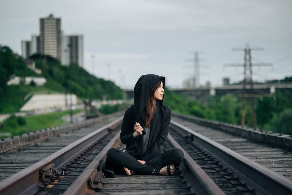 Woman Sitting on a Railway | Breast Cancer Car Donations