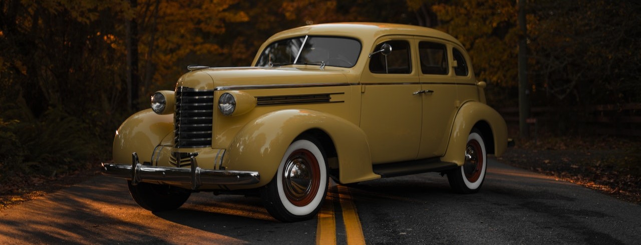 A Yellow Vintage Car on the Road | Breast Cancer Car Donations