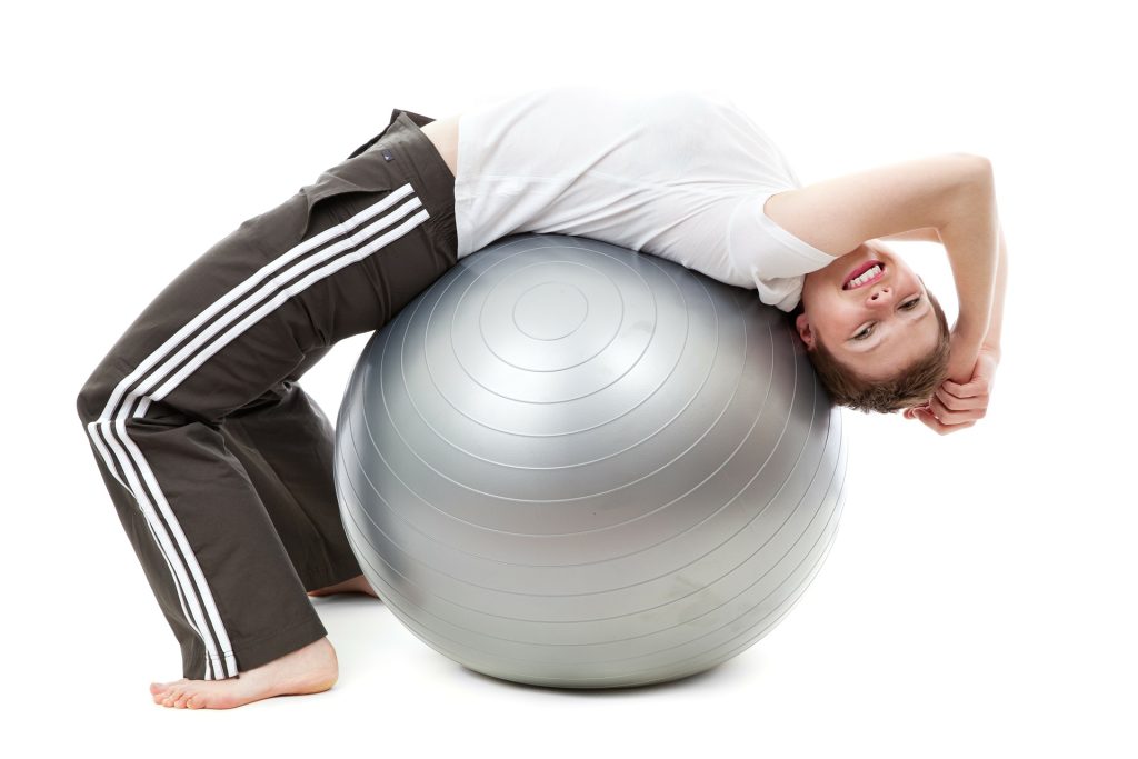 Woman on an Active Ball | Breast Cancer Car Donations