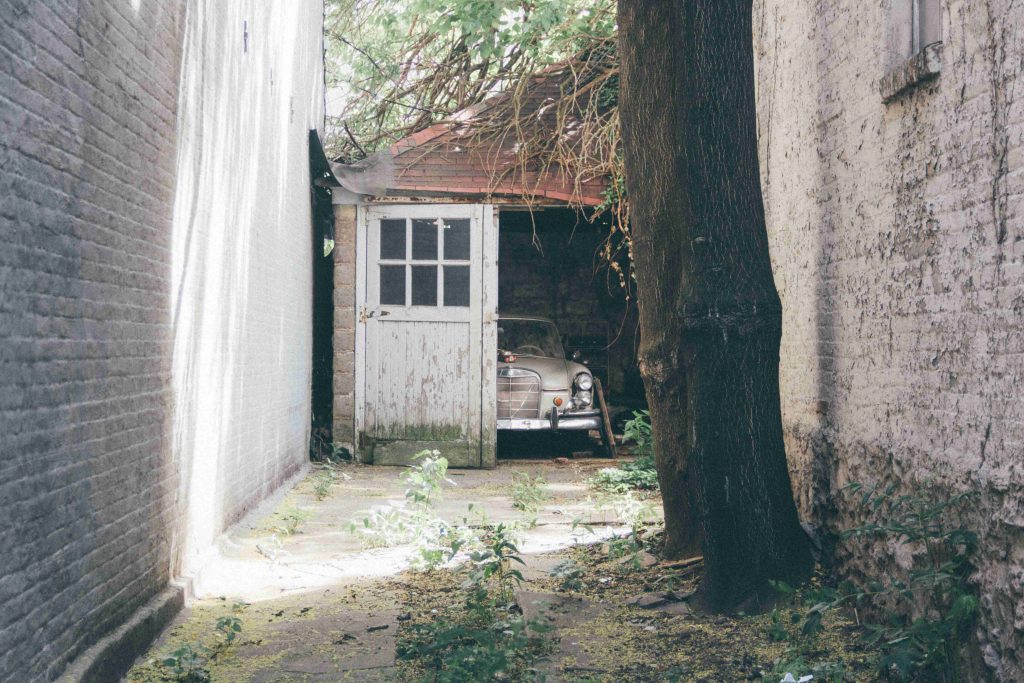 Old Car in an Abandoned Garage | Breast Cancer Car Donations