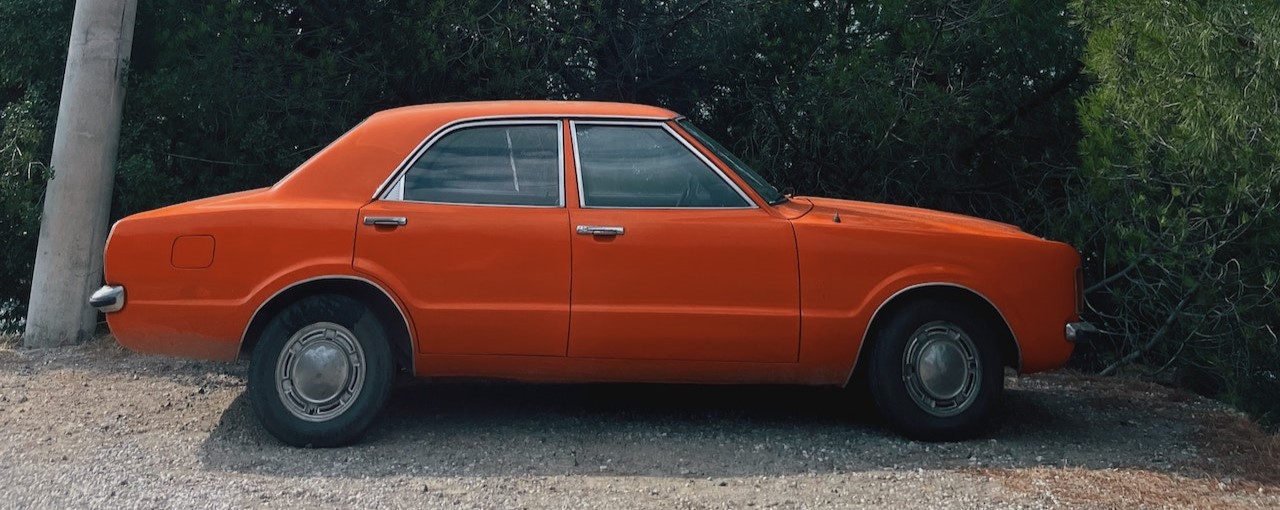 Orange Car Parked Near Green Trees | Breast Cancer Car Donations