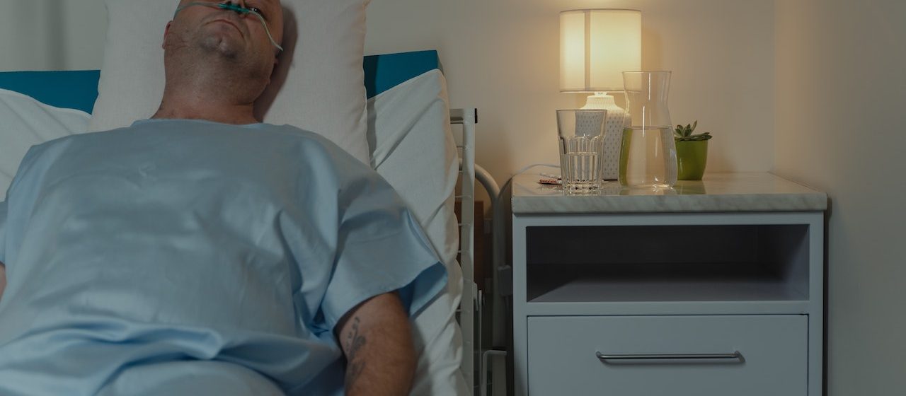 Sick Man Lying on Hospital Bed | Breast Cancer Car Donations