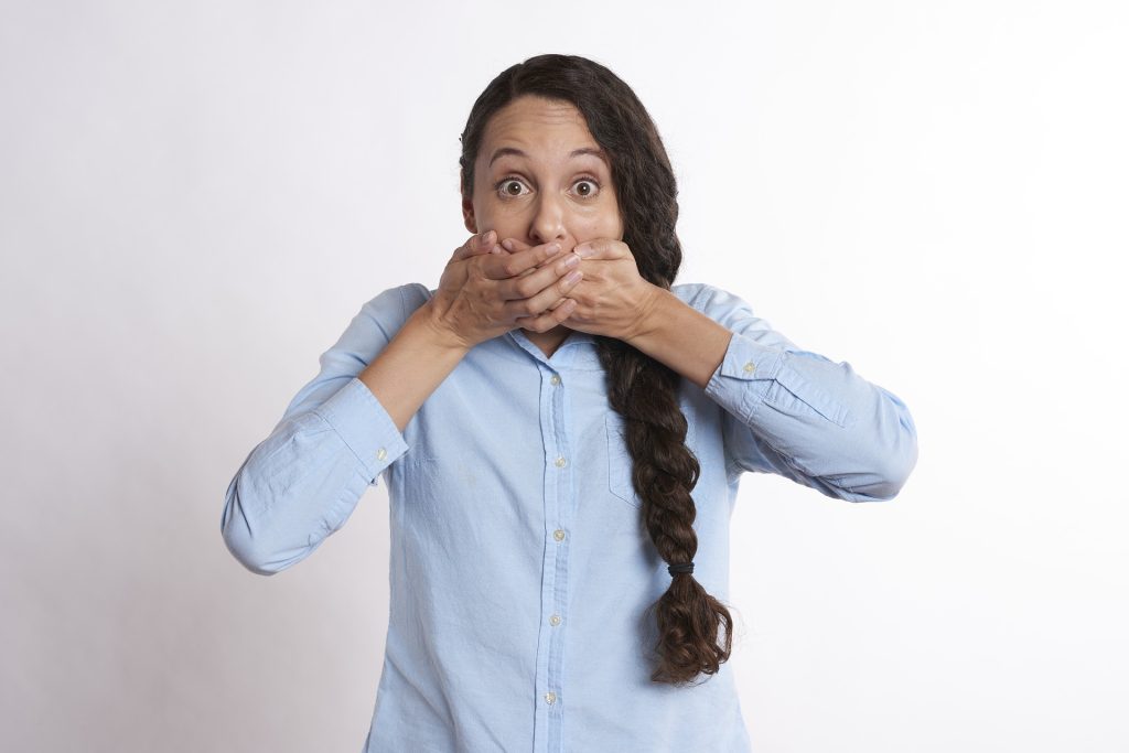 Woman Covering Mouth | Breast Cancer Car Donations