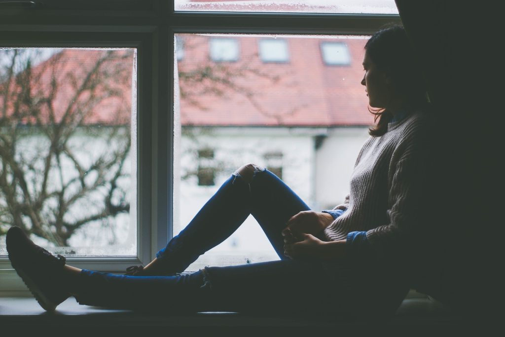 Woman Sitting on a Window | Breast Cancer Car Donations