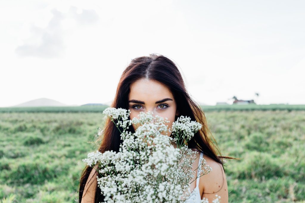 Young Woman Holding Flowers | Breast Cancer Car Donations