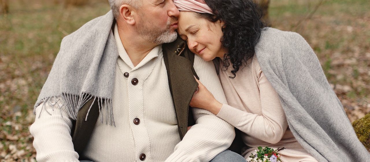 Happy senior couple hugging in autumn park | Breast Cancer Car Donations