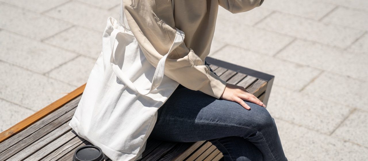 Close-Up Shot of a Person Sitting on Wooden Bench | Breast Cancer Car Donations