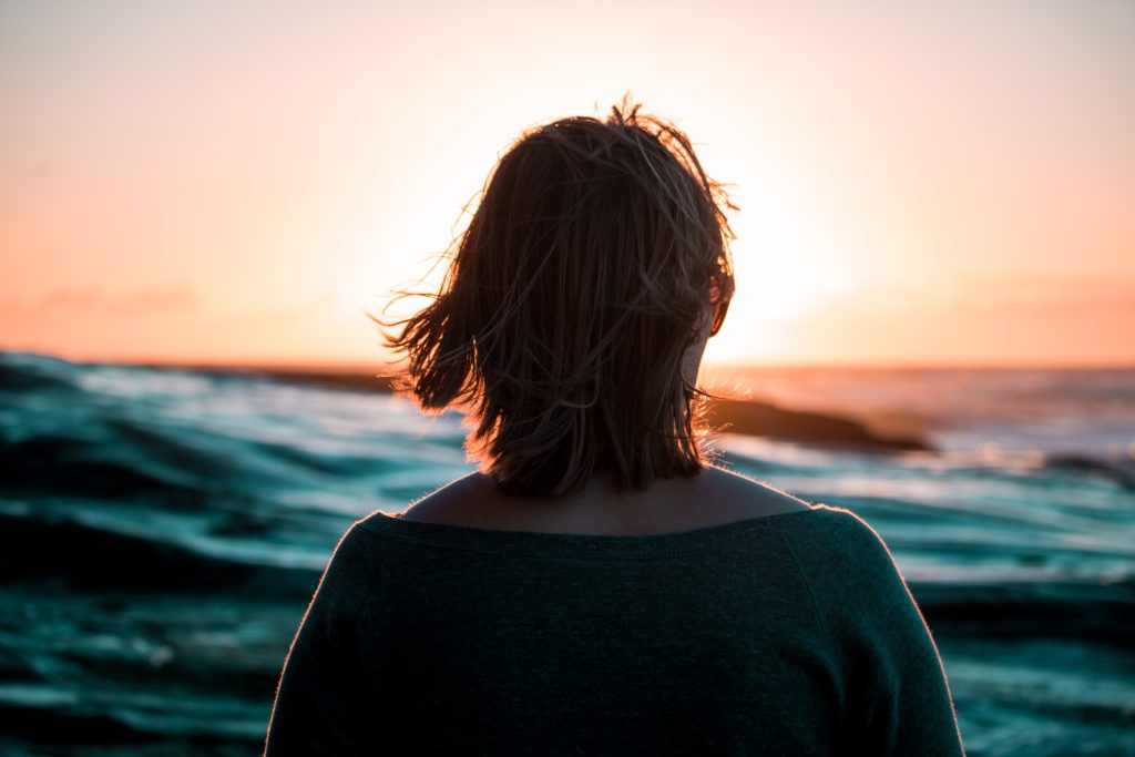 Woman in the Ocean Sunset | Breast Cancer Car Donations