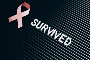 A Pink Ribbon Beside a Note on a Letter Board | Breast Cancer Car Donations