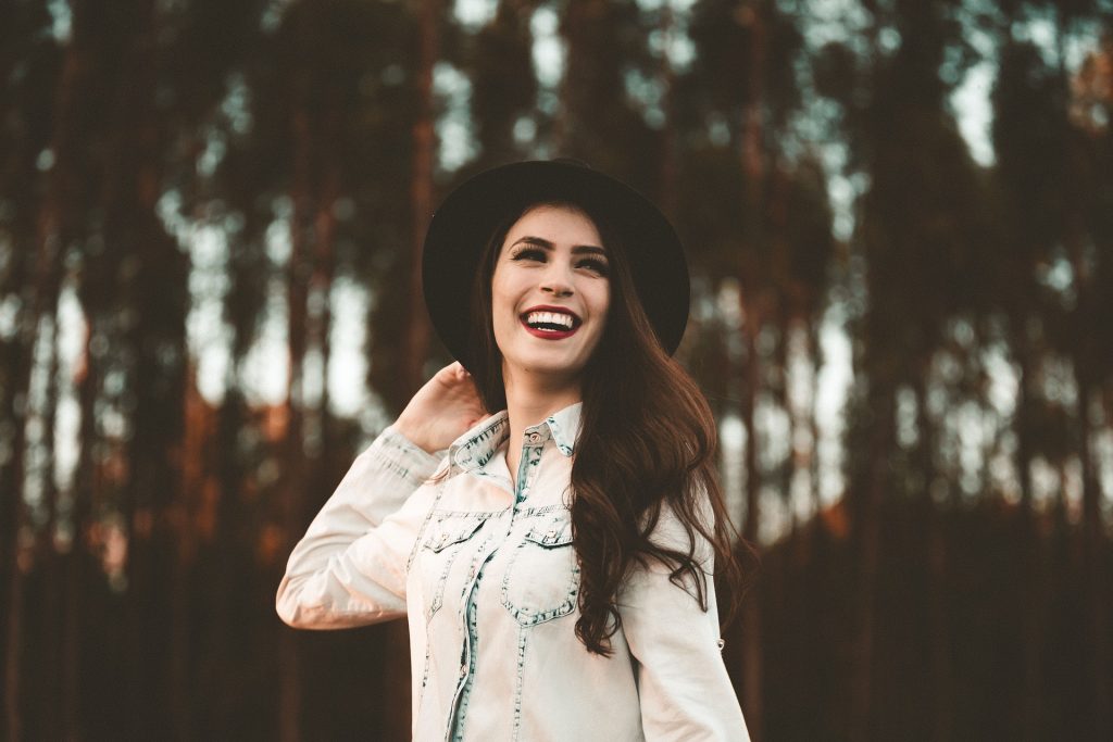 Happy Woman Wearing a Hat | Breast Cancer Car Donations