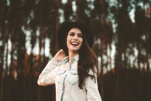 Happy Woman Wearing a Hat | Breast Cancer Car Donations