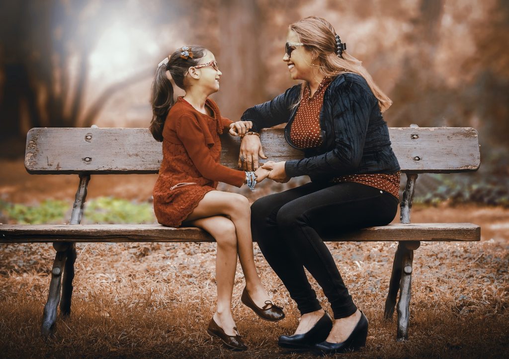 Mother And Daughter on a Bench Outdoors | Breast Cancer Car Donations