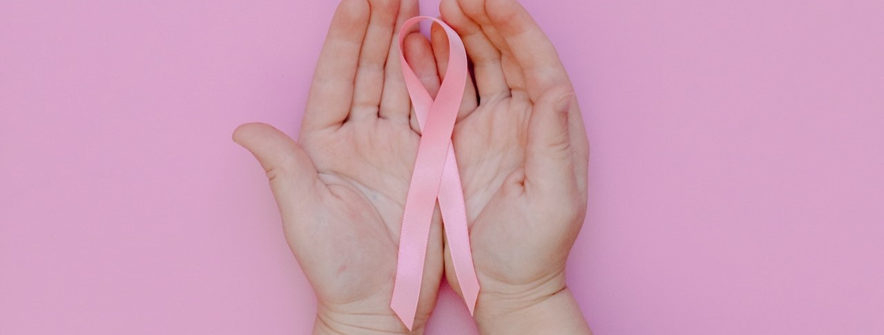 Person Holding Pink Ribbon | Breast Cancer Car Donations