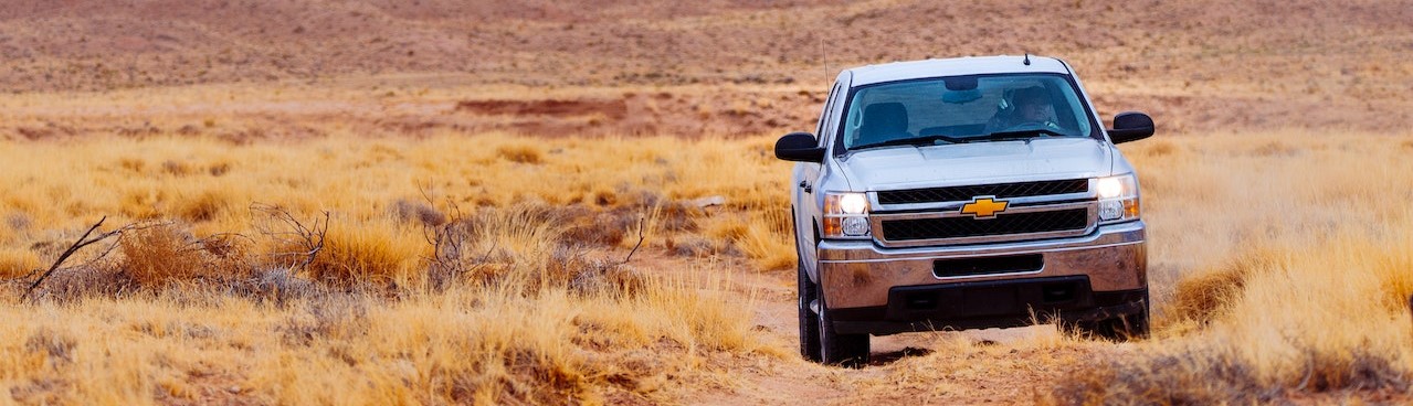 White Chevrolet Vehicle on Dessert | Breast Cancer Car Donations