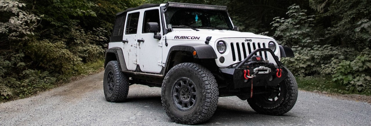 White Jeep Wrangler on Asphalt Road | Breast Cancer Car Donations