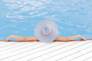 Woman Relaxing In a Pool | Breast Cancer Car Donations