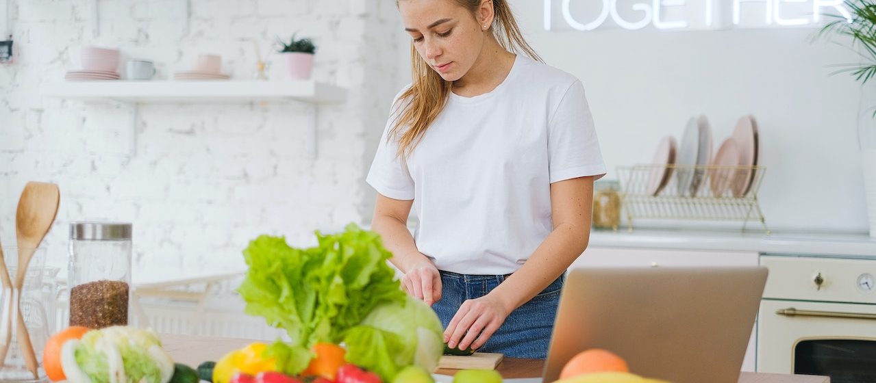 Woman Standing at Table with Vegetables | Breast Cancer Car Donations