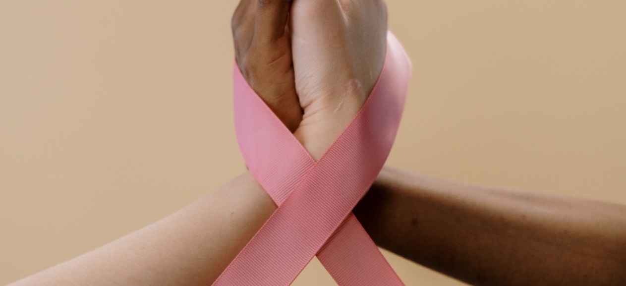 Hands tied with pink ribbon | Breast Cancer Car Donations